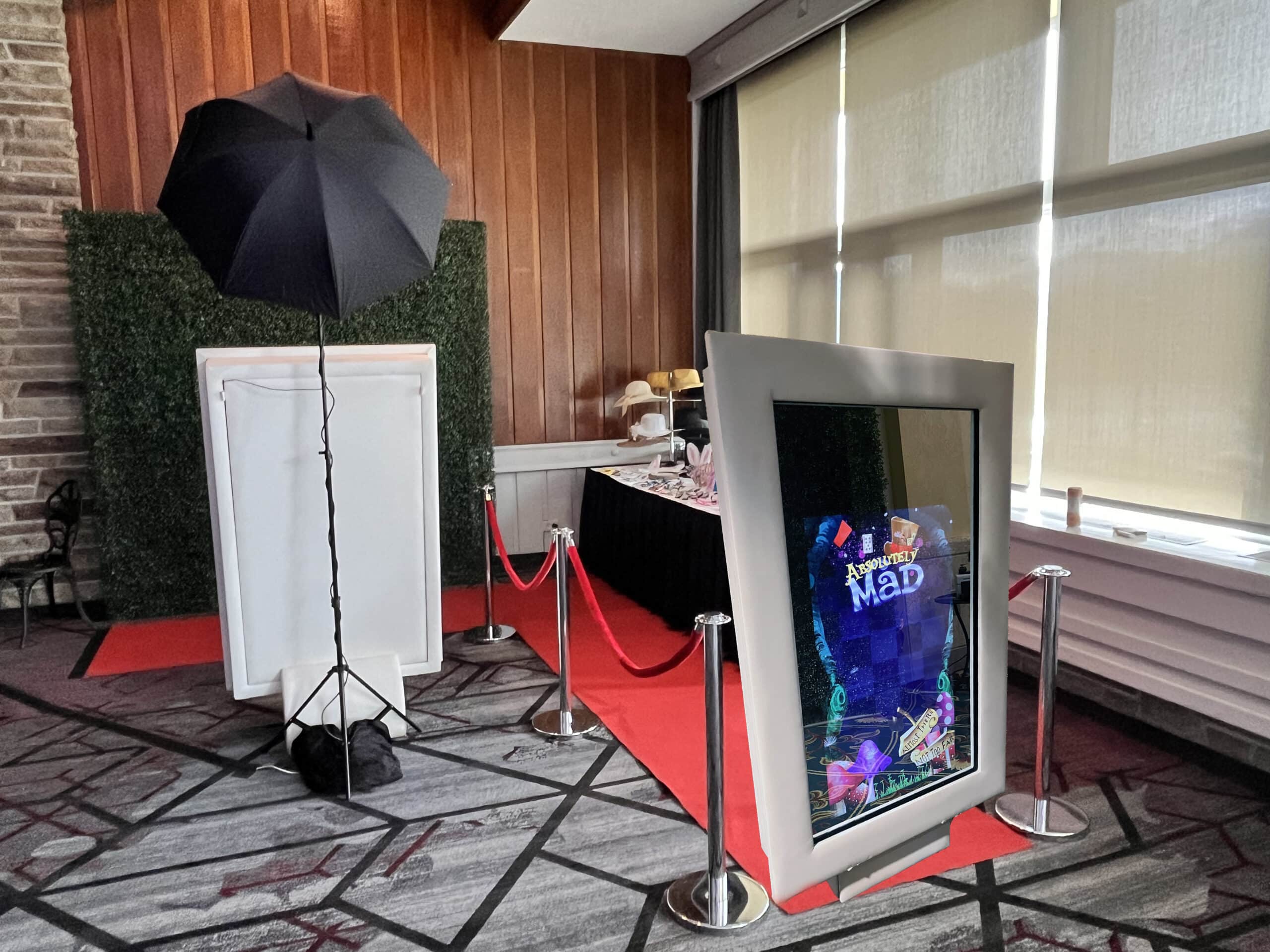 Mojo Mirror Photo Booth with red carpet and green hedge wall at the AMA AGM event, Jasper Fairmont Lodge, Edmonton, AB, Canada, Alice in Wonderland theme.