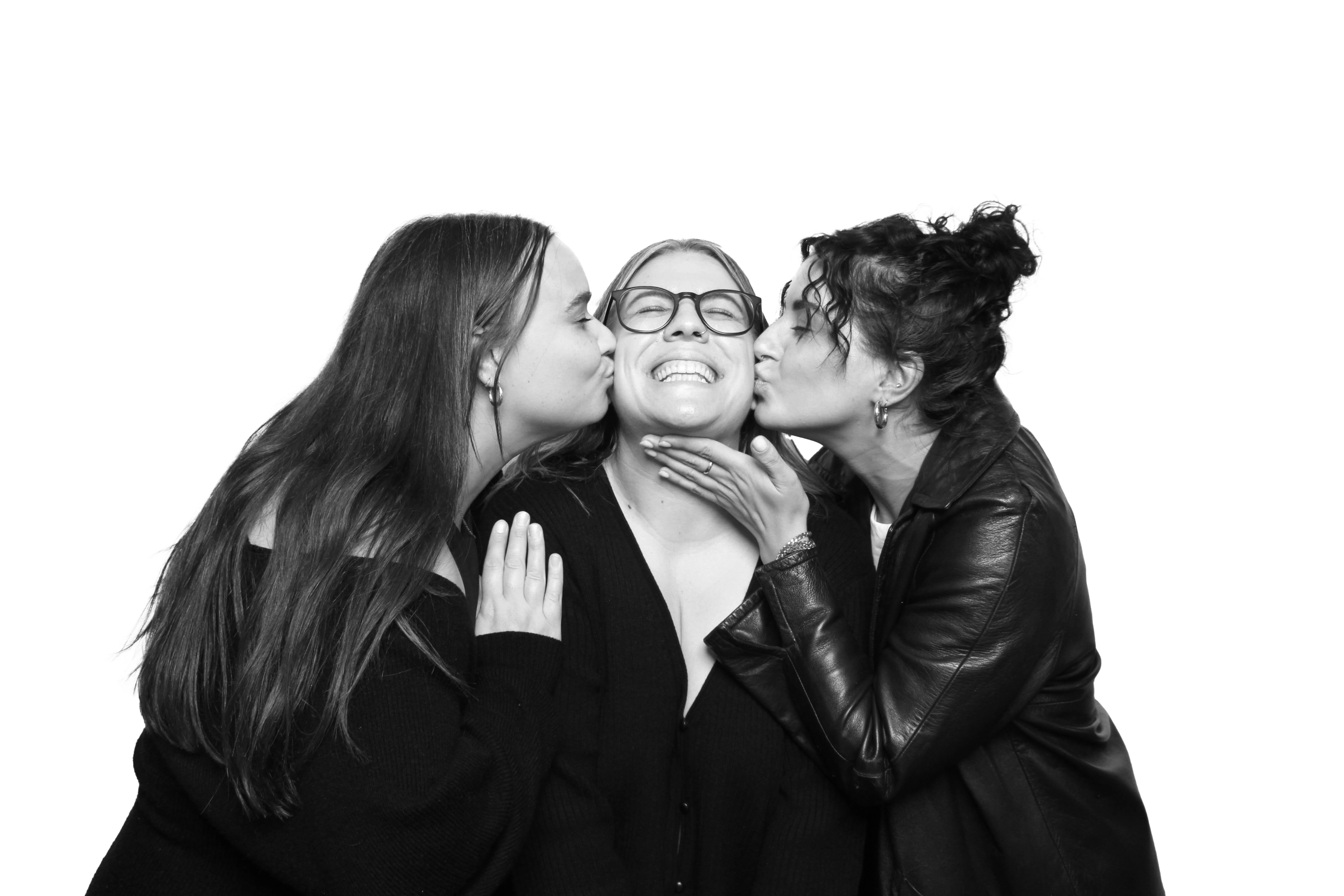 Photo of a person posing in the Glam Photo Booth with a chic backdrop, captured in a soft lighting effect for a red-carpet look.